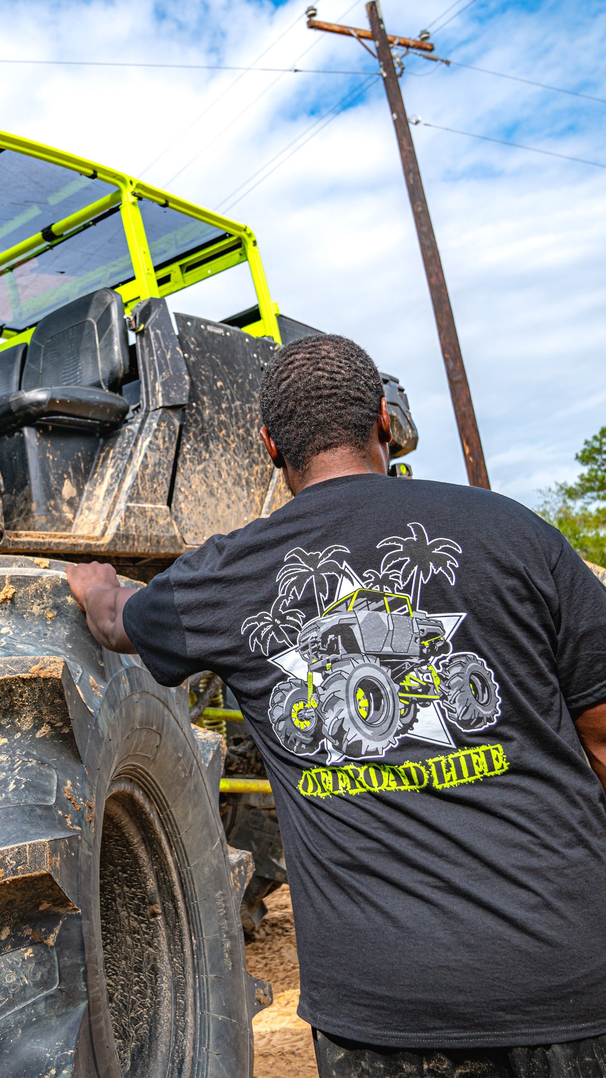Person wearing a black t-shirt with a polaris design, standing next to mega ranger thotiana.